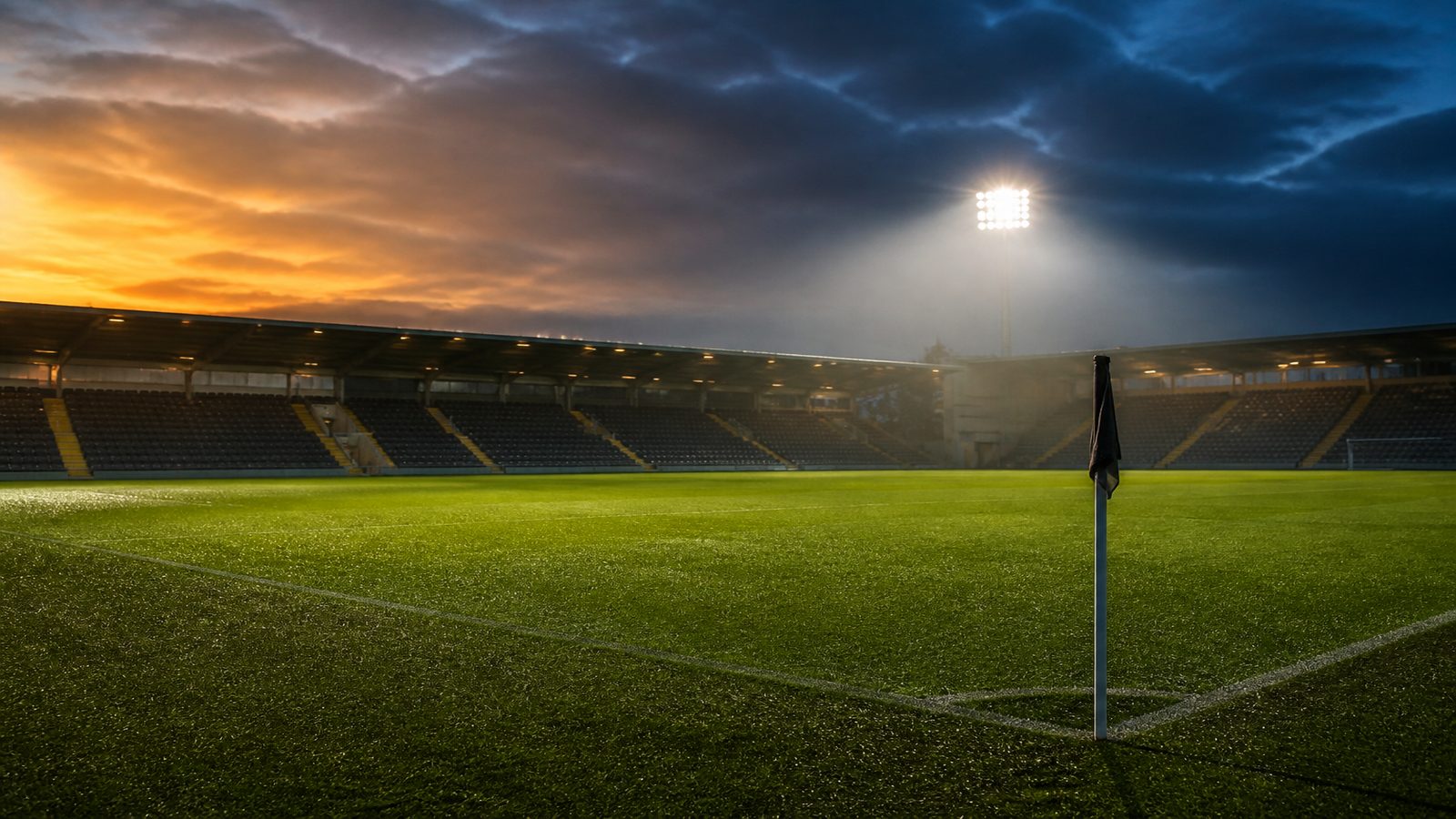Fotbollsplan i arena under strålkastarljus i skymning — atmosfär inför kval till Superettan
